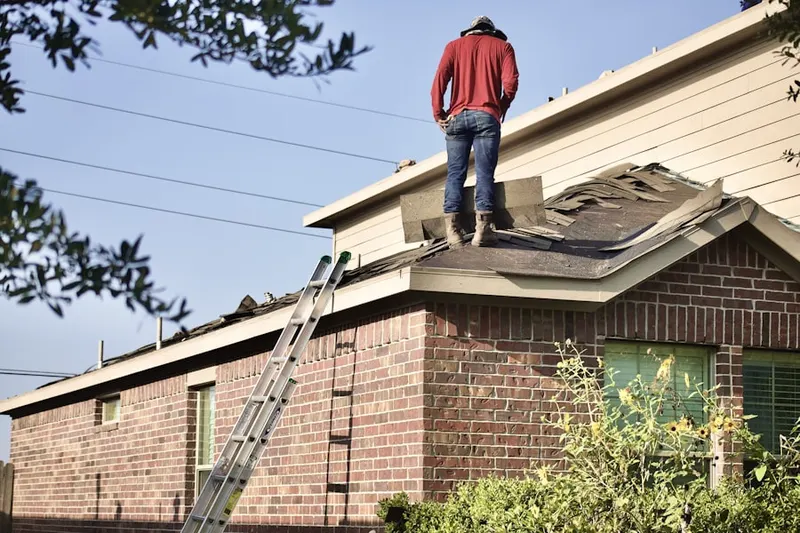 Professional roofer working on a residential roof in Kalispell